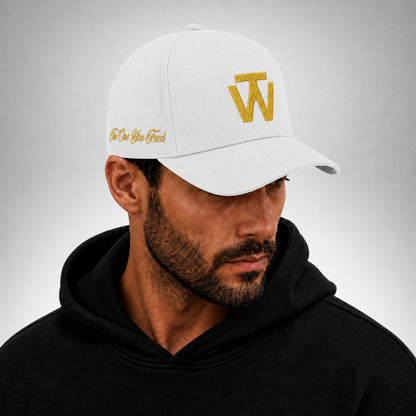 White Two Wolves cap with gold embroidered logo worn by male model