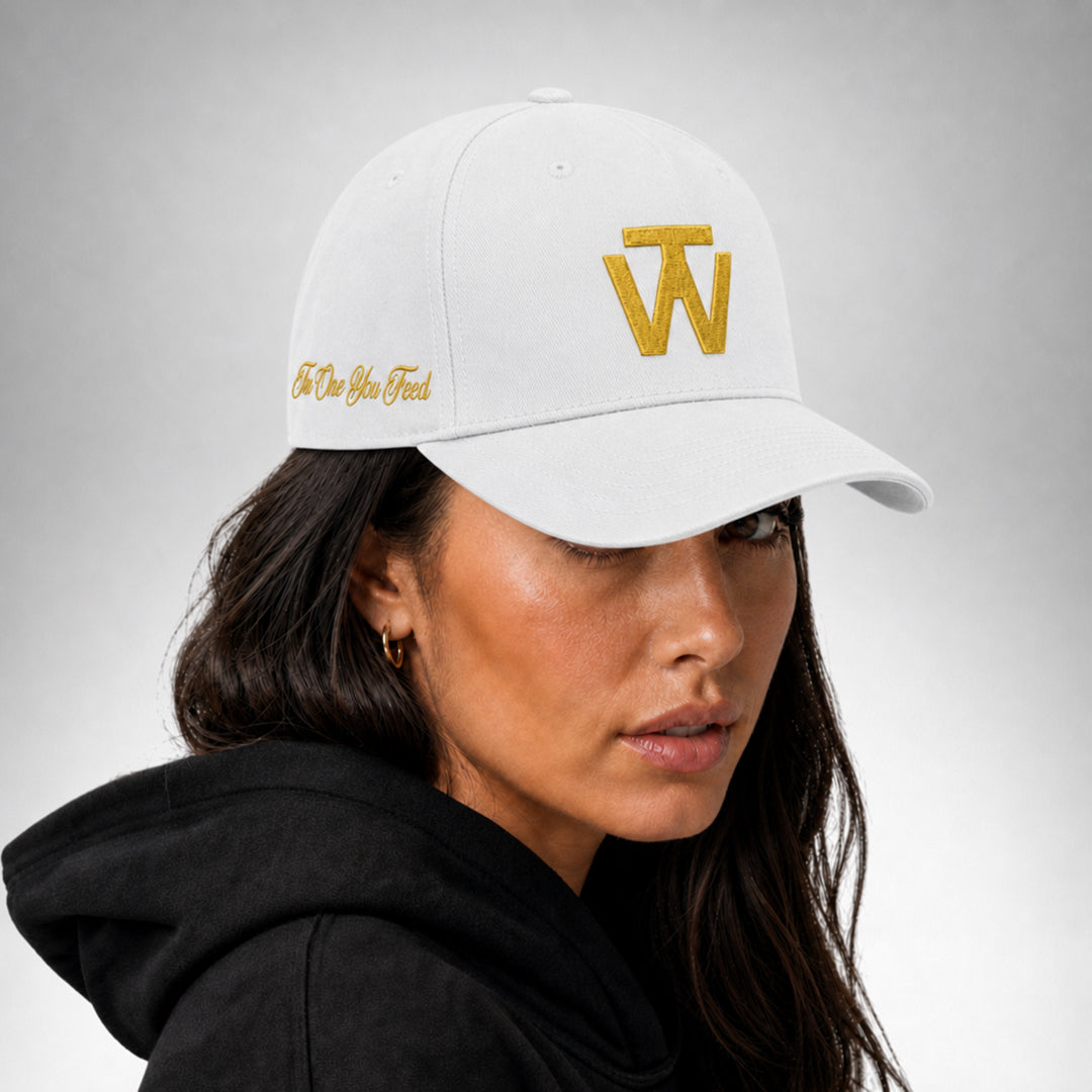 White Two Wolves cap with gold embroidered logo worn by female model