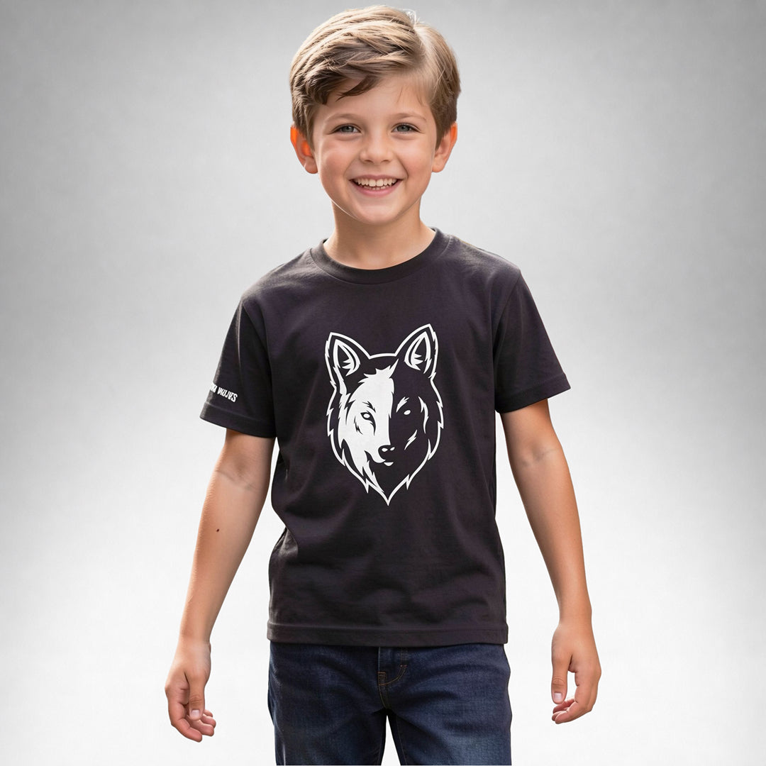 Boy wearing a black Two Wolves Cub Staple T-shirt with a white wolf graphic on the front