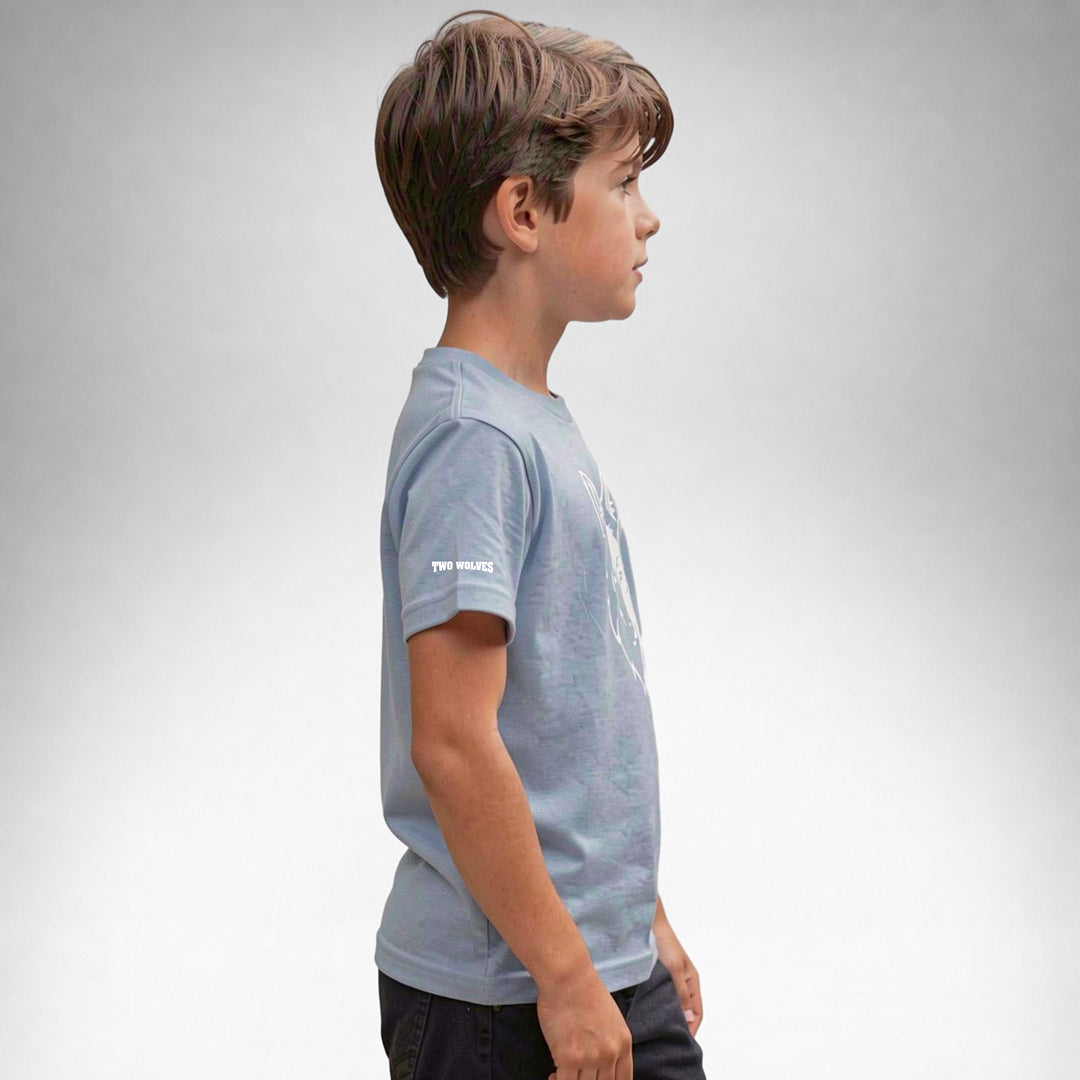 Boy wearing a blue Two Wolves Cub Staple T-shirt with a white wolf graphic, facing sideway.