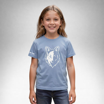 Girl wearing a blue Two Wolves Cub Staple T-shirt with a white wolf graphic on the front.