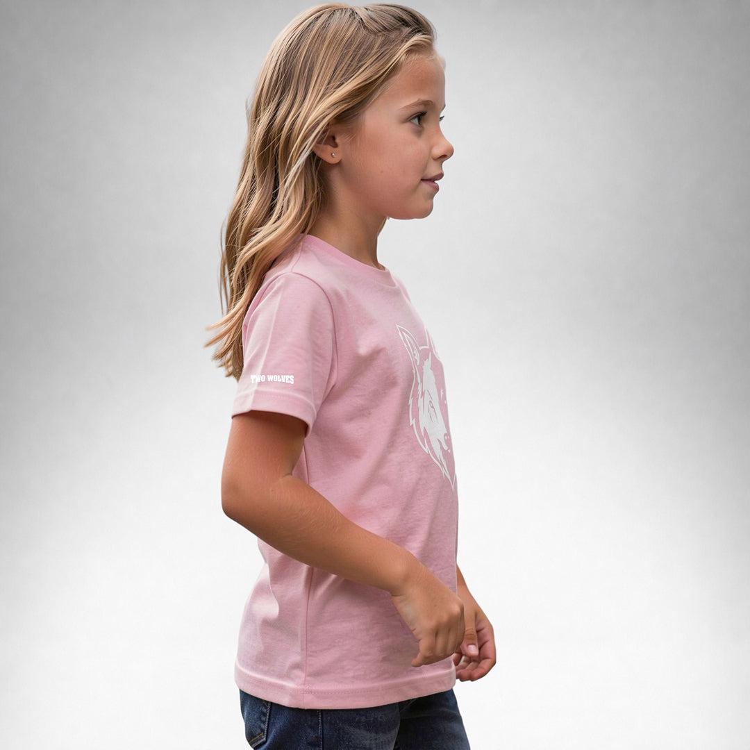 Girl wearing a pink Two Wolves Cub Staple T-shirt with a white wolf graphic, facing sideway.