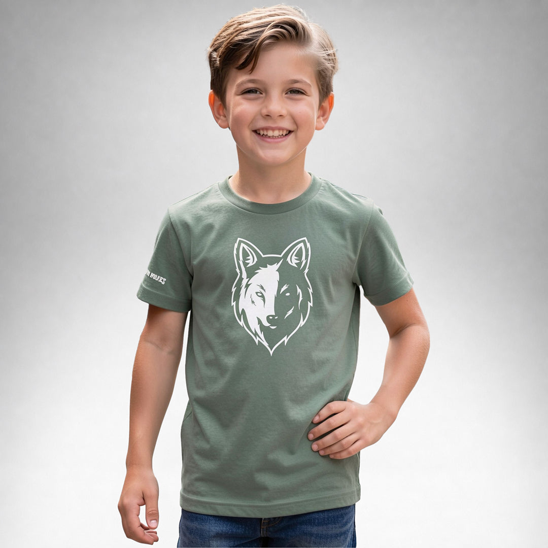 Boy wearing a sage Two Wolves Cub Staple T-shirt with a white wolf graphic on the front.