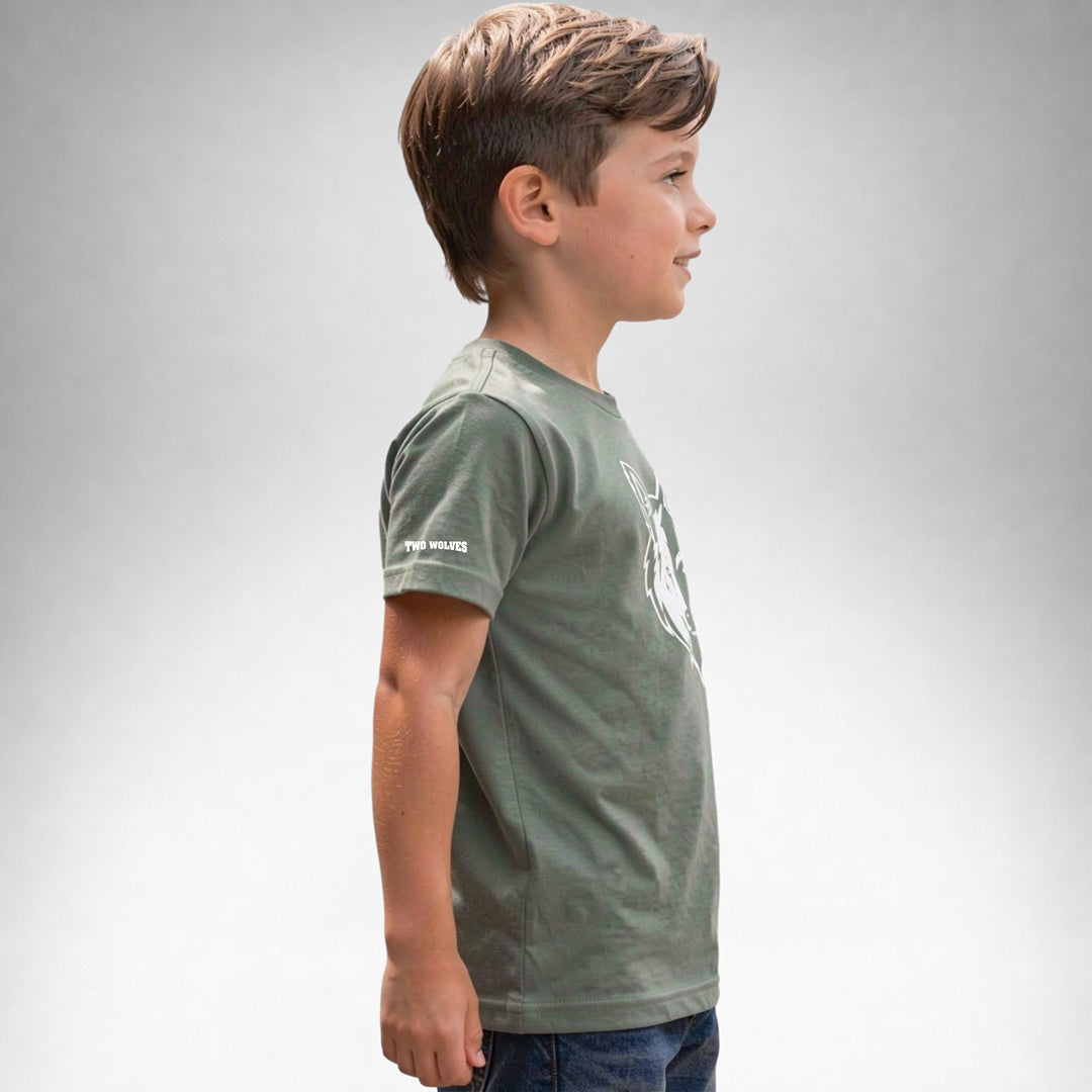 Boy wearing a Sage Two Wolves Cub Staple T-shirt with a white wolf graphic, facing sideway.