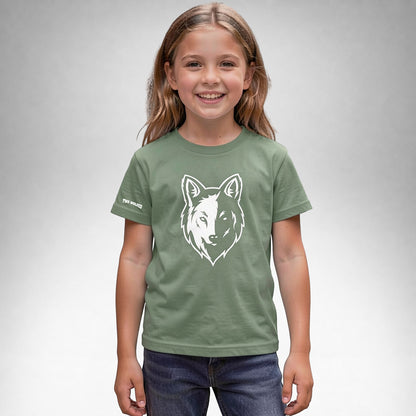 Girl wearing a sage Two Wolves Cub Staple T-shirt with a white wolf graphic on the front.