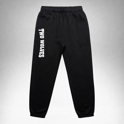 Black Two Wolves track pants with white logo on leg, front part