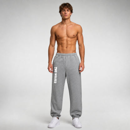 Grey Two Wolves track pants with white logo on leg, worn by male model