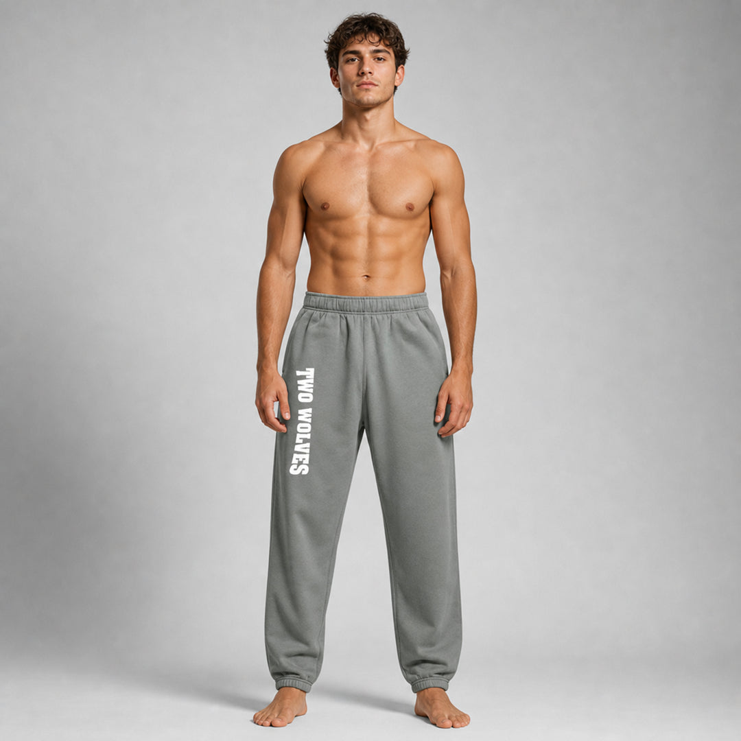 Shadow Two Wolves track pants with white logo on leg, worn by male model