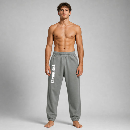 Shadow Two Wolves track pants with white logo on leg, worn by male model